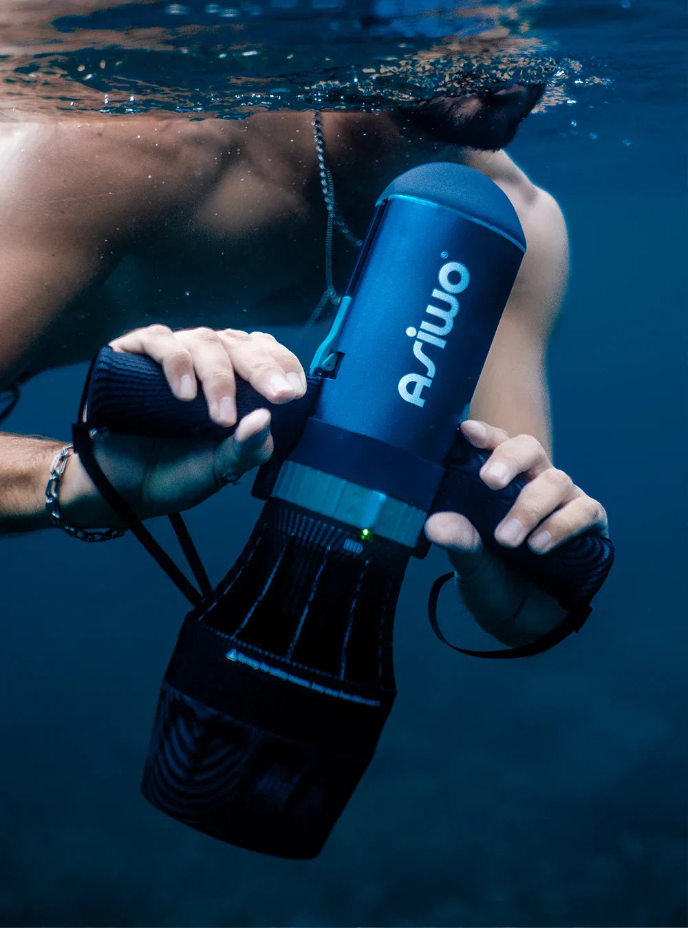 A swimmer partially submerged underwater holding the Asiwo U1 sea scooter with both hands, showcasing its compact and powerful design.
