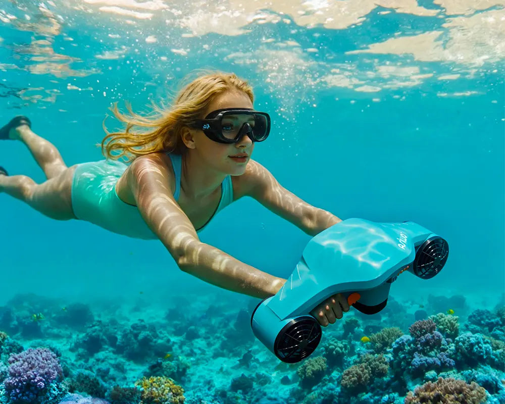 Snorkeler using an underwater scooter for reef exploration over colorful coral in clear tropical water